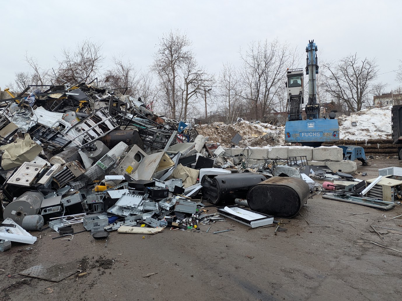 Electronic scrap yard with excavator